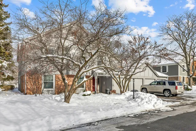 a view of a house with a yard covered in snow