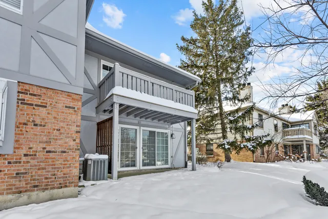 a front view of a building with a garden