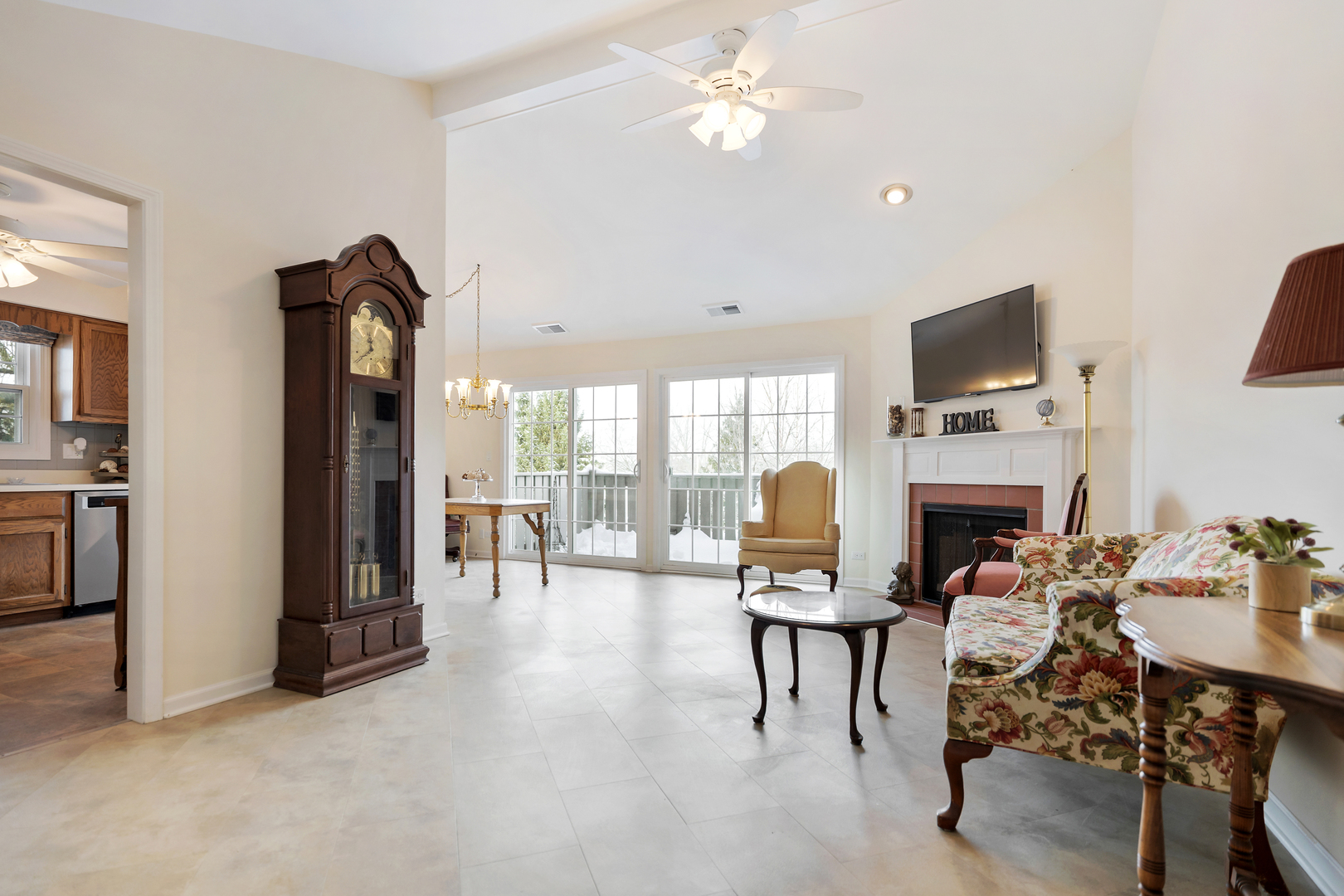 1907 Gresham Circle, Unit D Wheaton, IL 60189 - Photo 4 of 26 a living room with furniture a fireplace and a flat screen tv