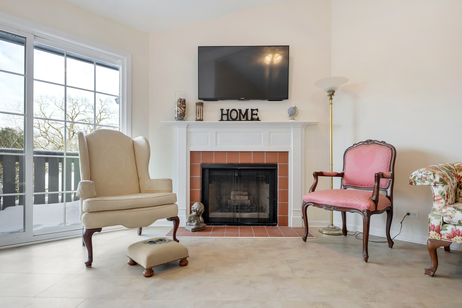 1907 Gresham Circle, Unit D Wheaton, IL 60189 - Photo 6 of 26 a living room with furniture a flat screen tv and a fireplace