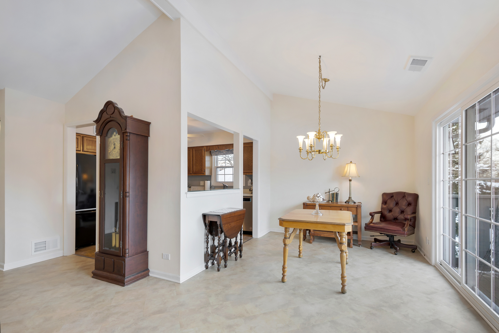 1907 Gresham Circle, Unit D Wheaton, IL 60189 - Photo 7 of 26 a room with furniture and a chandelier