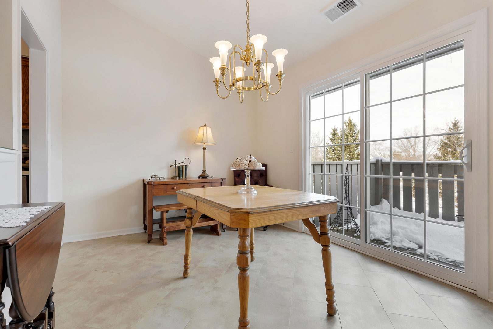 1907 Gresham Circle, Unit D Wheaton, IL 60189 - Photo 8 of 26 a view of a dining room with furniture a chandelier and a window