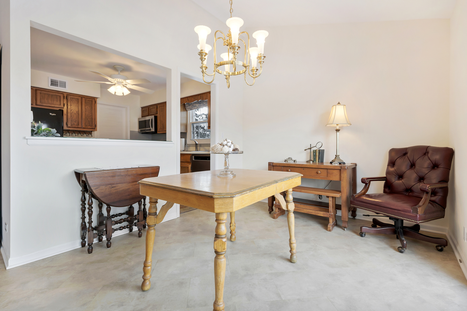 1907 Gresham Circle, Unit D Wheaton, IL 60189 - Photo 9 of 26 a view of a dining room with furniture and a chandelier