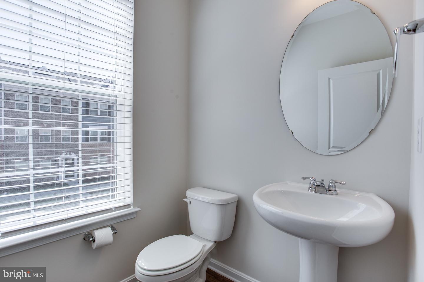 7068 Delegate Place Frederick, MD 21703 - Photo 34 of 76 a bathroom with a sink a mirror and a toilet