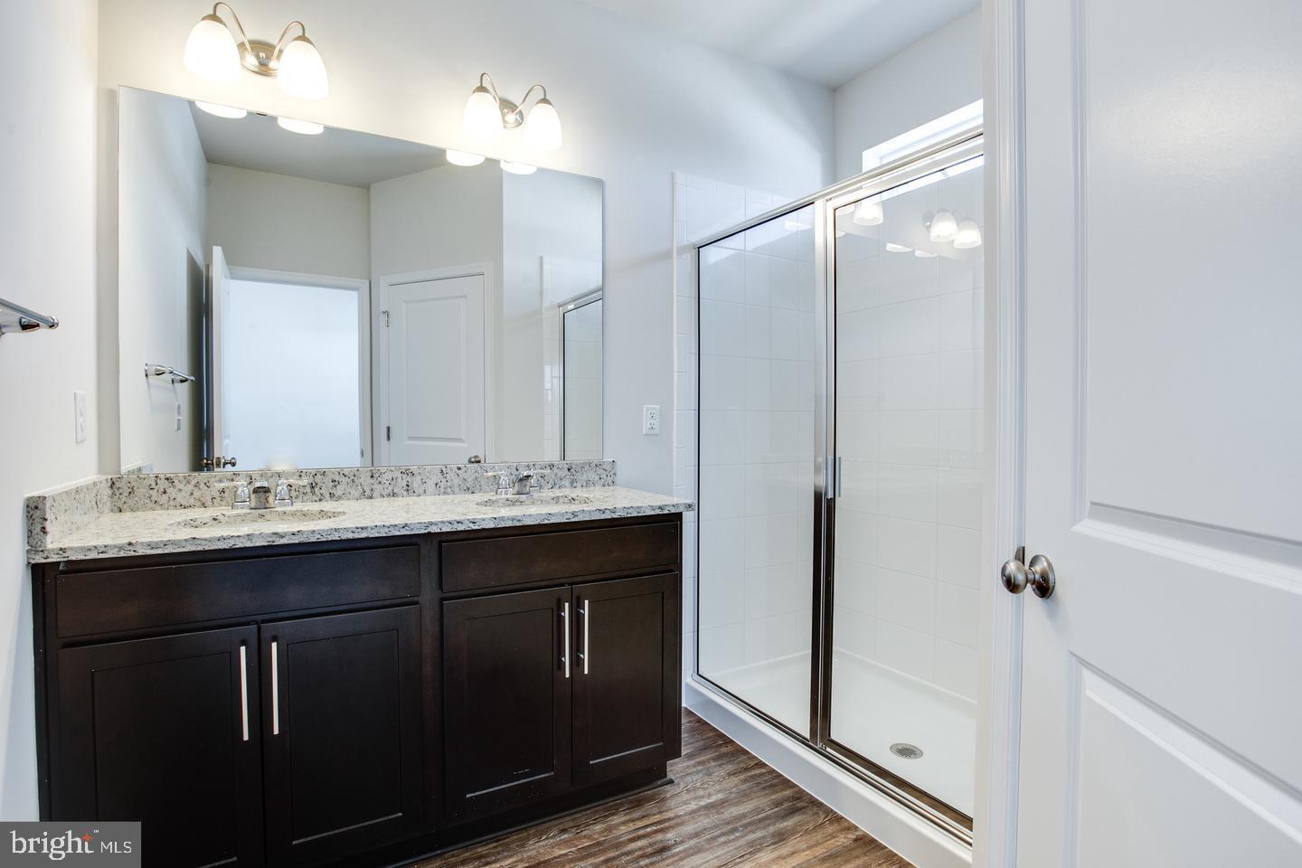 7068 Delegate Place Frederick, MD 21703 - Photo 39 of 76 a bathroom with a double vanity sink and mirror