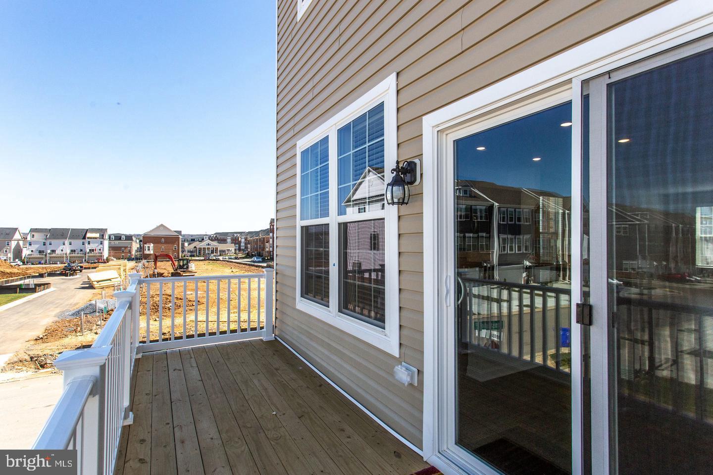7068 Delegate Place Frederick, MD 21703 - Photo 47 of 76 a view of a balcony with wooden floor and iron stairs