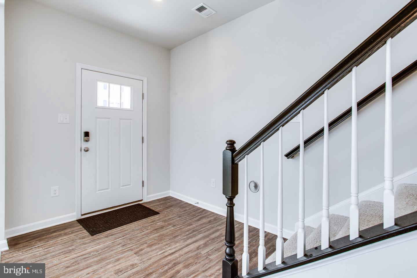 7068 Delegate Place Frederick, MD 21703 - Photo 9 of 76 a view of entryway with wooden floor and stairs