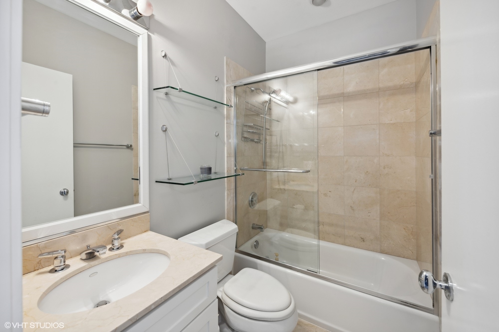 222 South Racine Avenue, Unit 48 Chicago, IL 60607 - Photo 12 of 21 a bathroom with a sink vanity mirror and shower