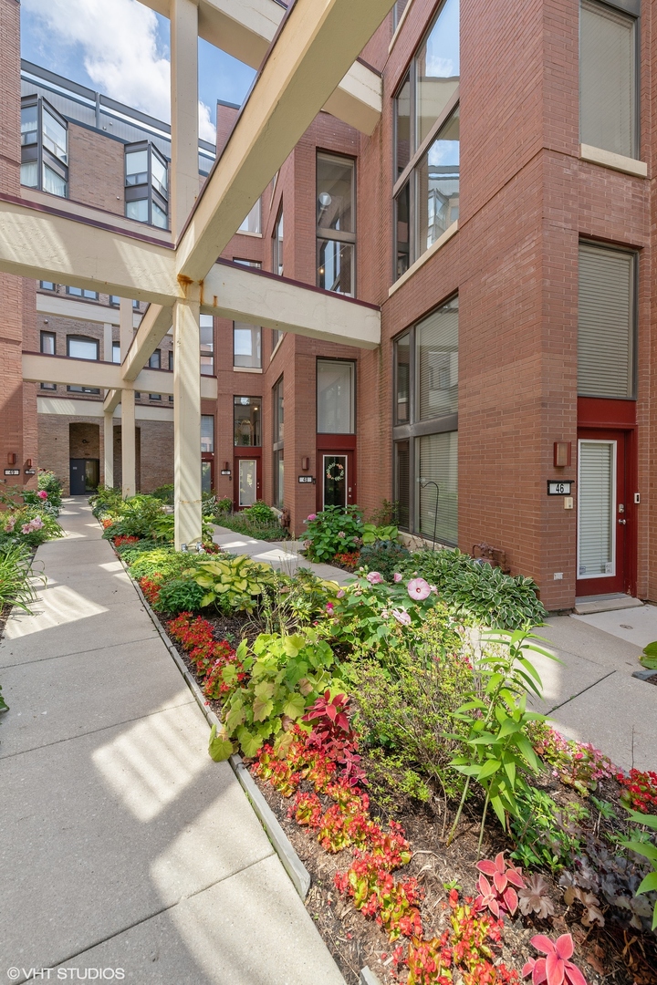 222 South Racine Avenue, Unit 48 Chicago, IL 60607 - Photo 2 of 21 front view of a brick building with a yard