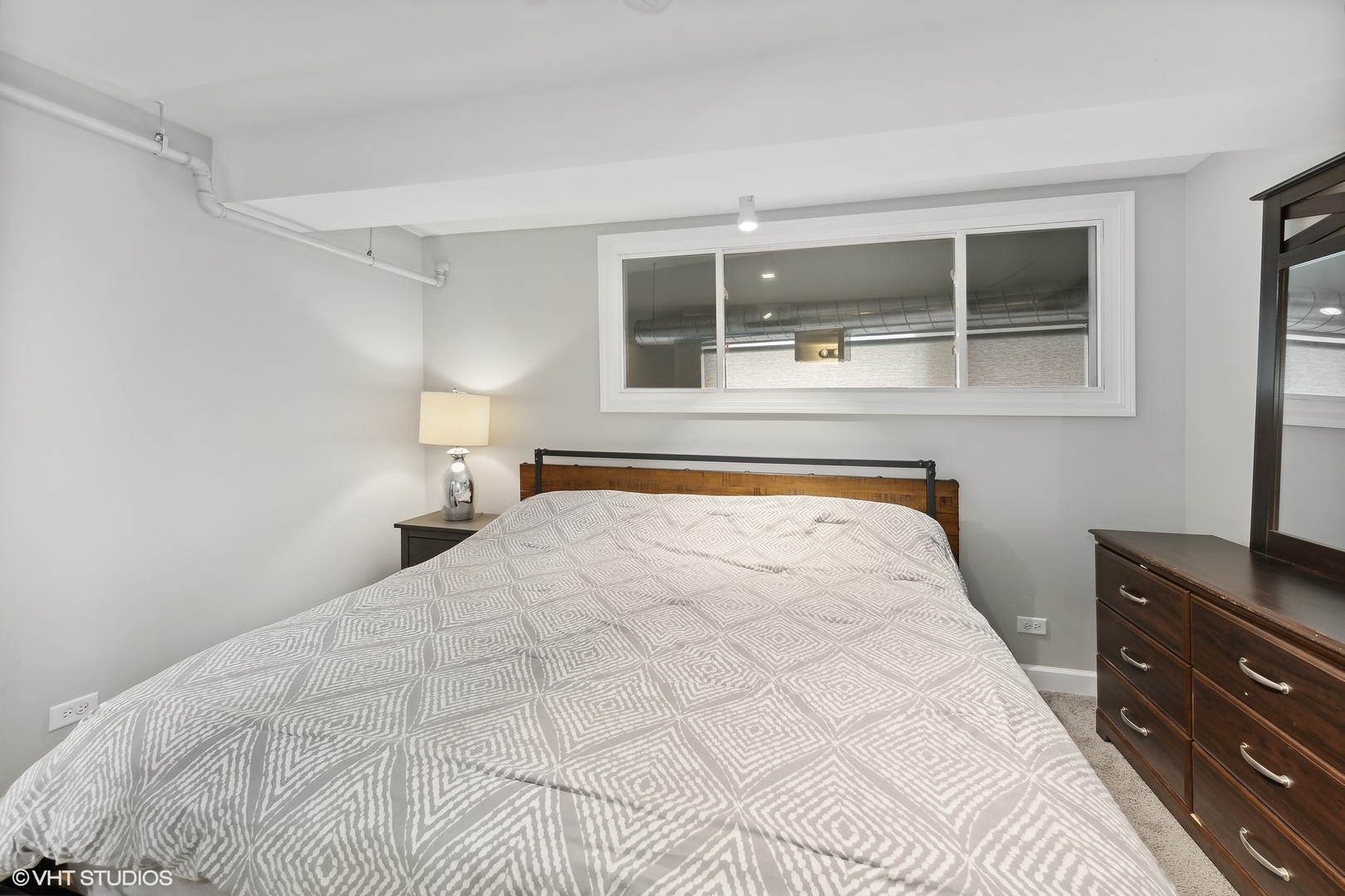 222 South Racine Avenue, Unit 48 Chicago, IL 60607 - Photo 5 of 21 a bedroom with a large bed and a window