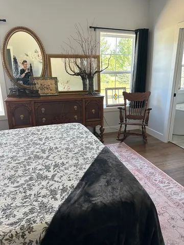 a bed sitting in a bedroom next to a window