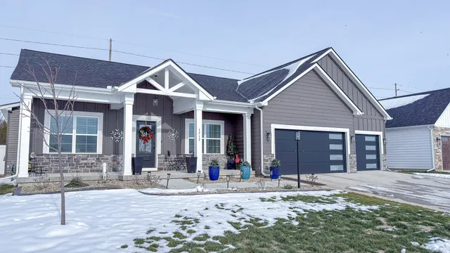 a front view of a house with a yard and potted plants