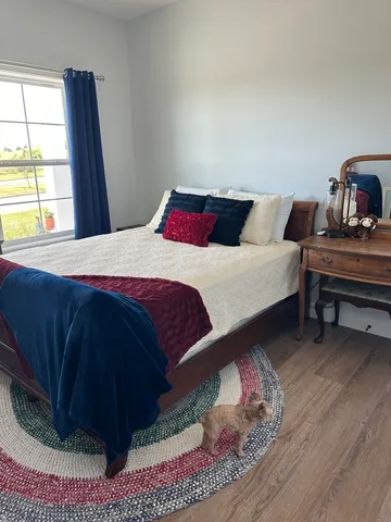 a bedroom with a bed and a window