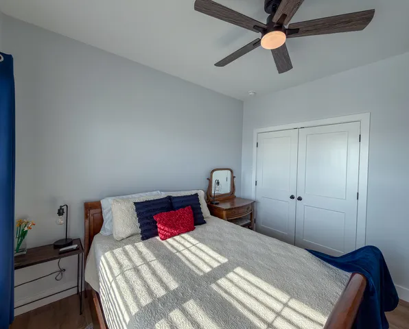 a bedroom with a bed and a chandelier