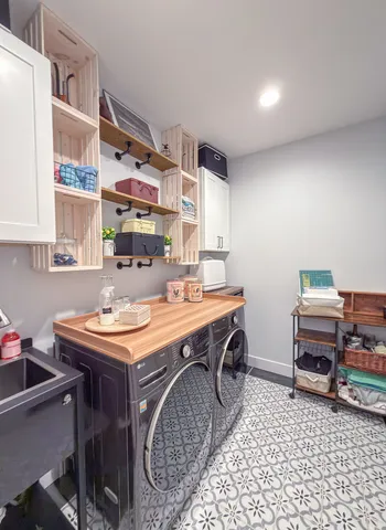 a room with a washing machine and a sink