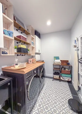 a room with a table chairs and a workspace