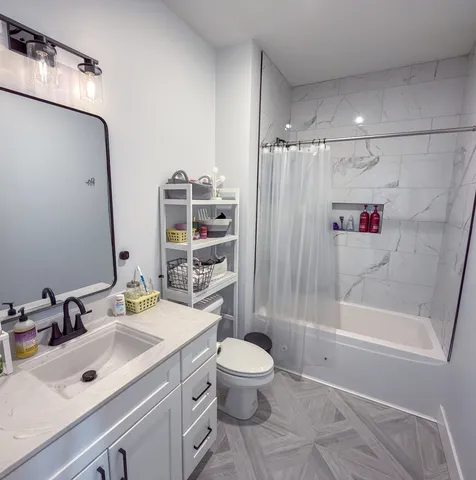 a bathroom with a sink toilet and shower