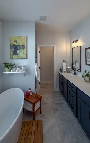 a spacious bathroom with a tub double vanity and sink