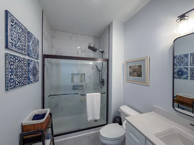 a white toilet sitting next to a bathroom sink