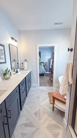 a spacious bathroom with a double vanity sink and a mirror