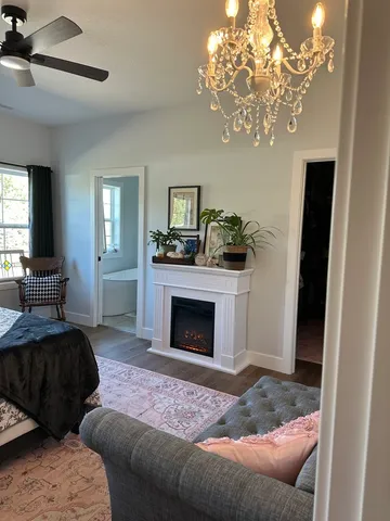 a bedroom with a bed and a chandelier