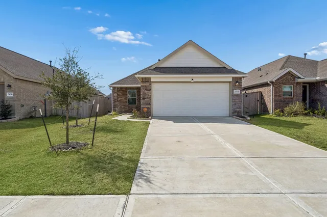 a front view of a house with a yard and a garage
