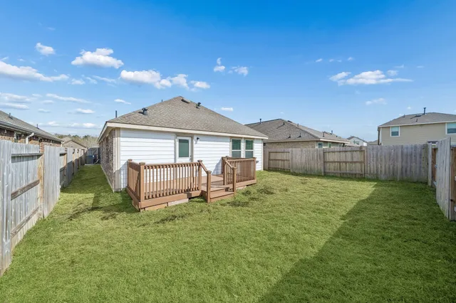 a front view of a house with a garden and yard