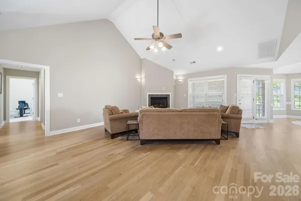 a living room with furniture and a wooden floor
