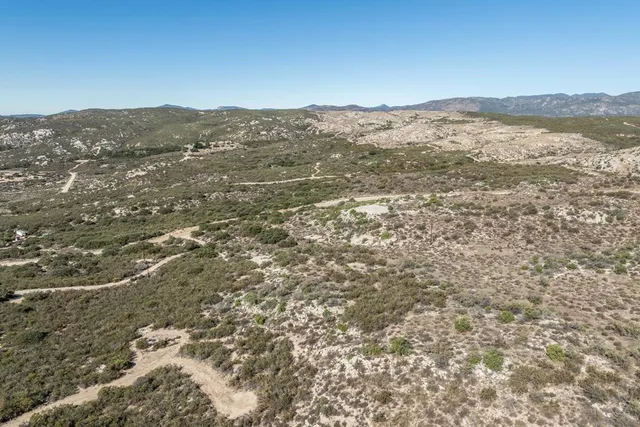 a view of a mountain in the distance in a field