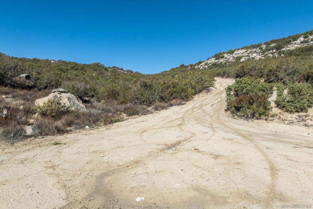 35613 Stagecoach Springs Road Pine Valley, CA 91962 - Photo 5 of 28 a view of a dry yard with mountains in the background