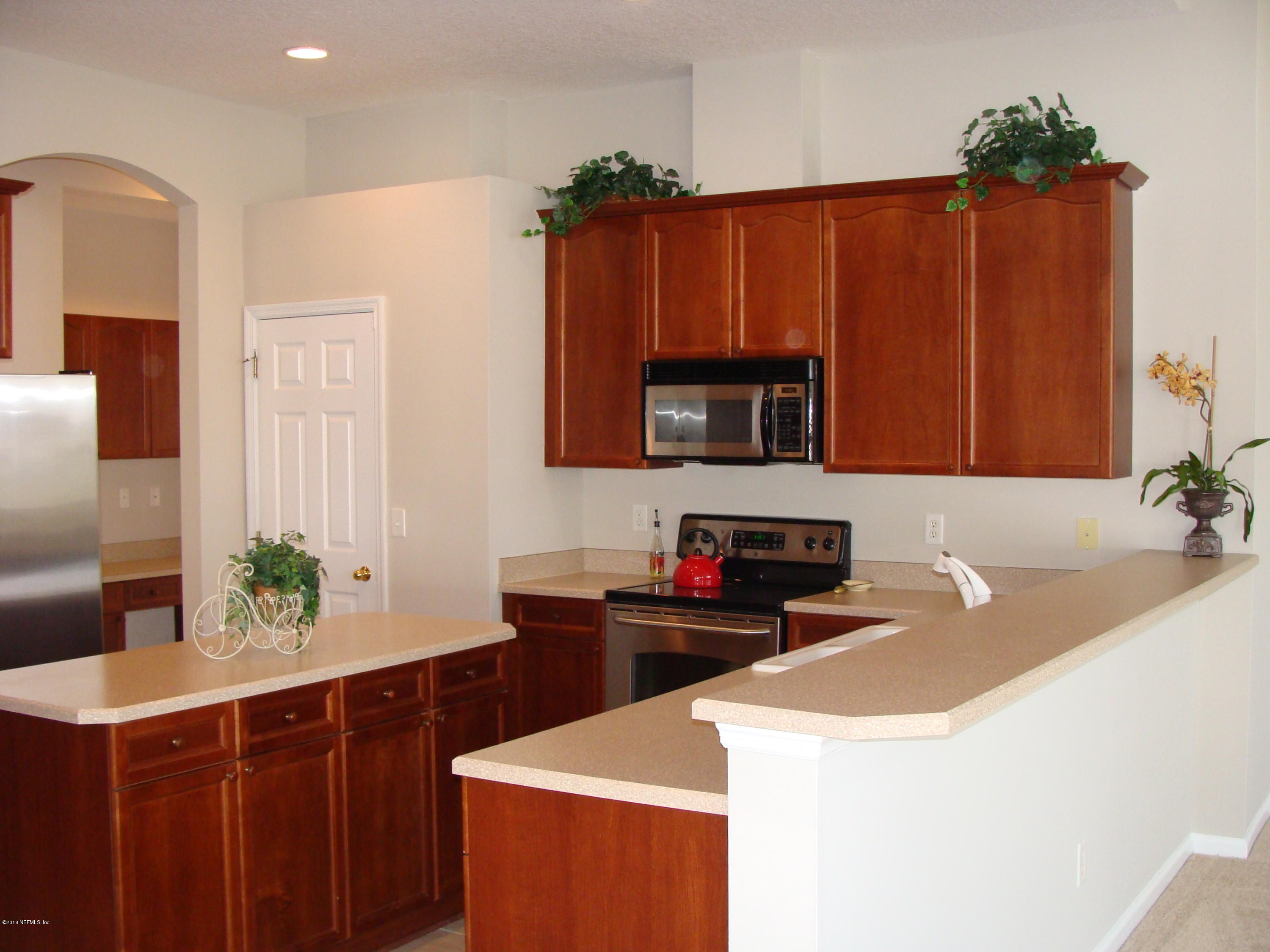 258 Porta Rosa Circle St. Augustine, FL 32092 - Photo 18 of 37 a kitchen with a sink and a microwave