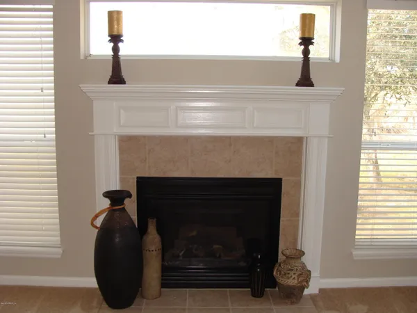 a living room with a fireplace and a window