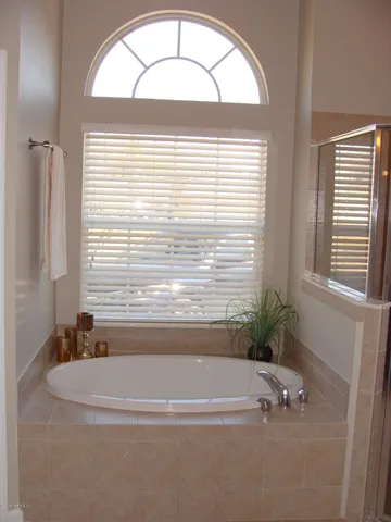 a bathroom with a bathtub and a window