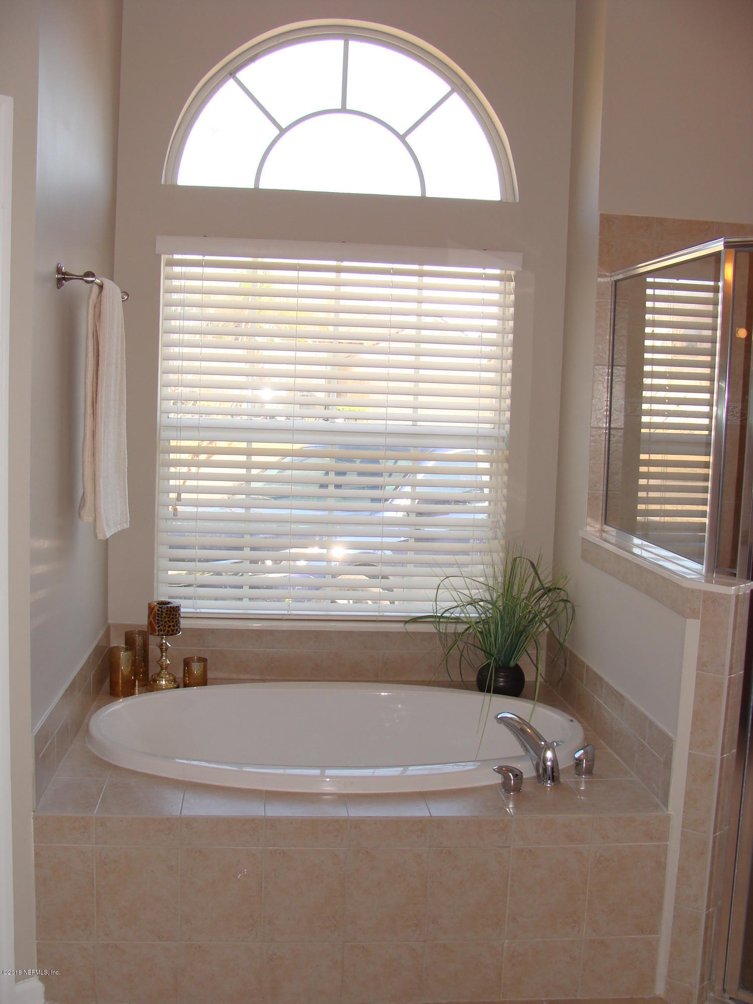 258 Porta Rosa Circle St. Augustine, FL 32092 - Photo 21 of 37 a bathroom with a bathtub and a window