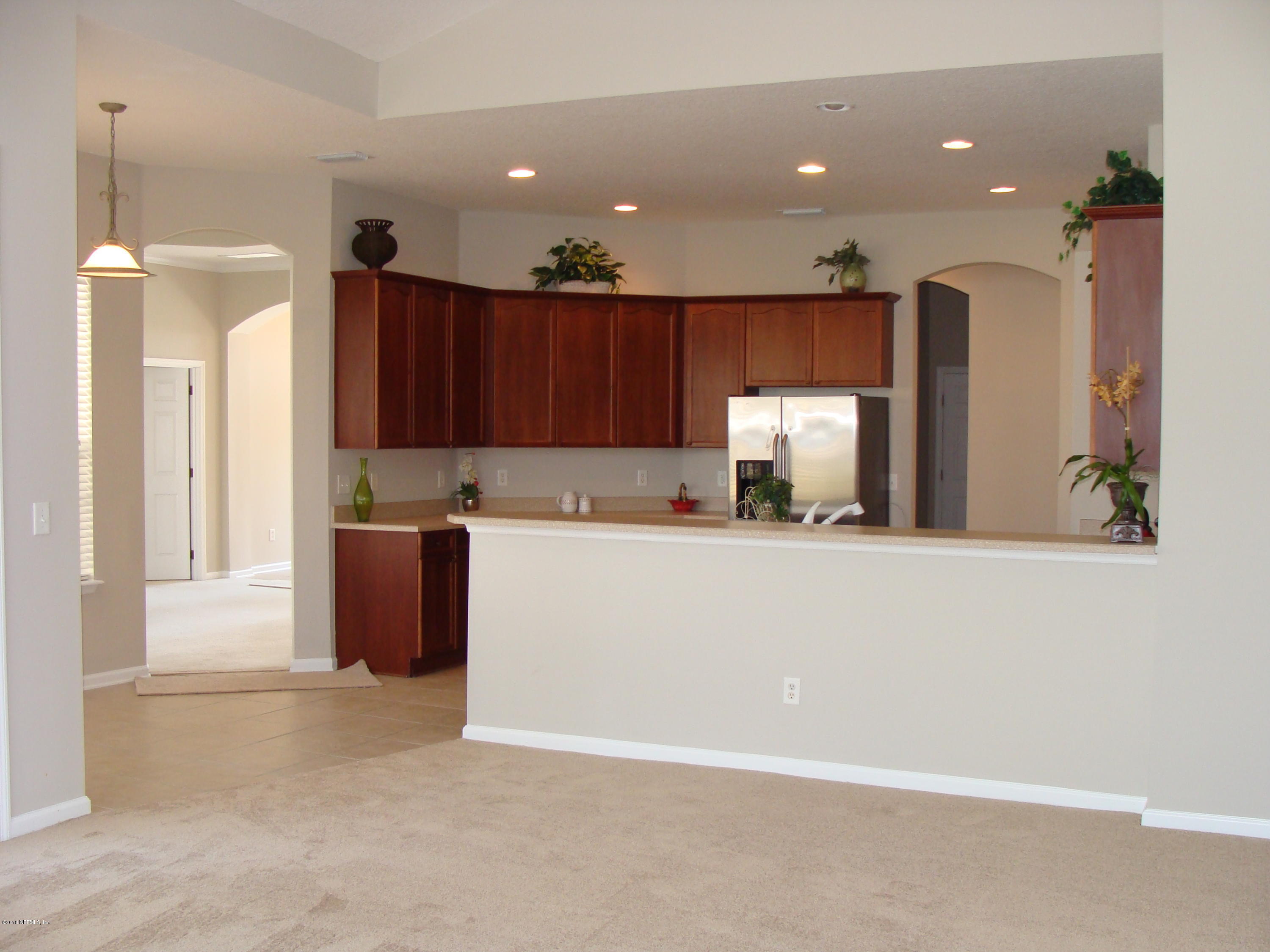 258 Porta Rosa Circle St. Augustine, FL 32092 - Photo 4 of 37 a view of kitchen with stainless steel appliances granite countertop refrigerator sink and wooden cabinets
