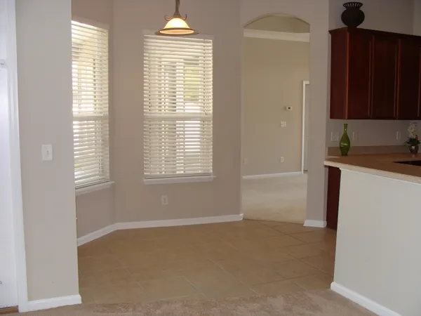 a living room with a fireplace and a large window