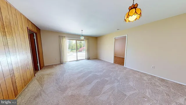 an empty room with windows and wooden floor