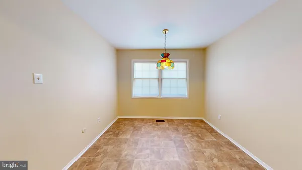 an empty room with window and painted walls