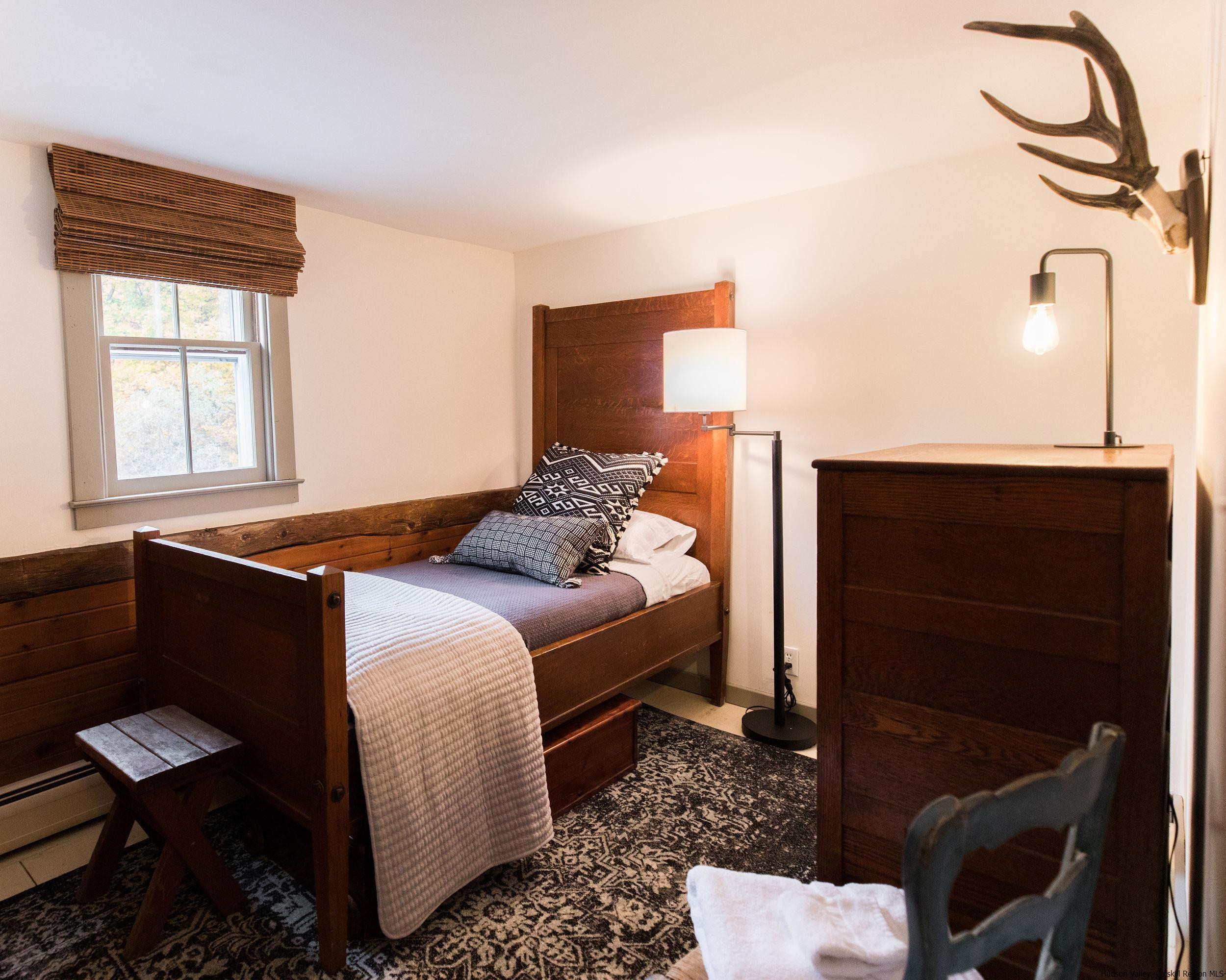 30 Old Farm Road Stone Ridge, NY 12484 - Photo 22 of 30 a bedroom with a bed and a chair