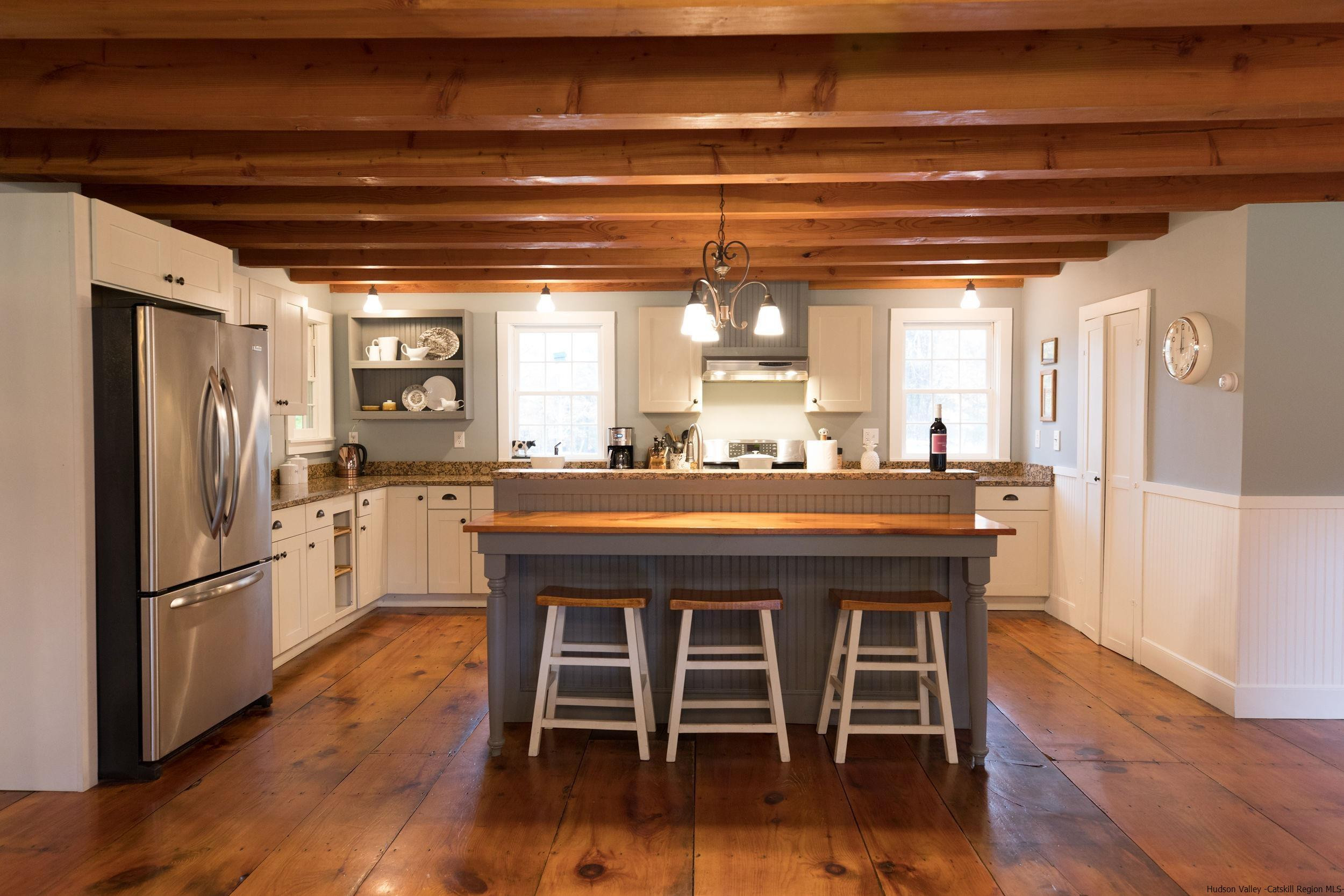 30 Old Farm Road Stone Ridge, NY 12484 - Photo 7 of 30 a kitchen with stainless steel appliances granite countertop a table chairs stove and refrigerator