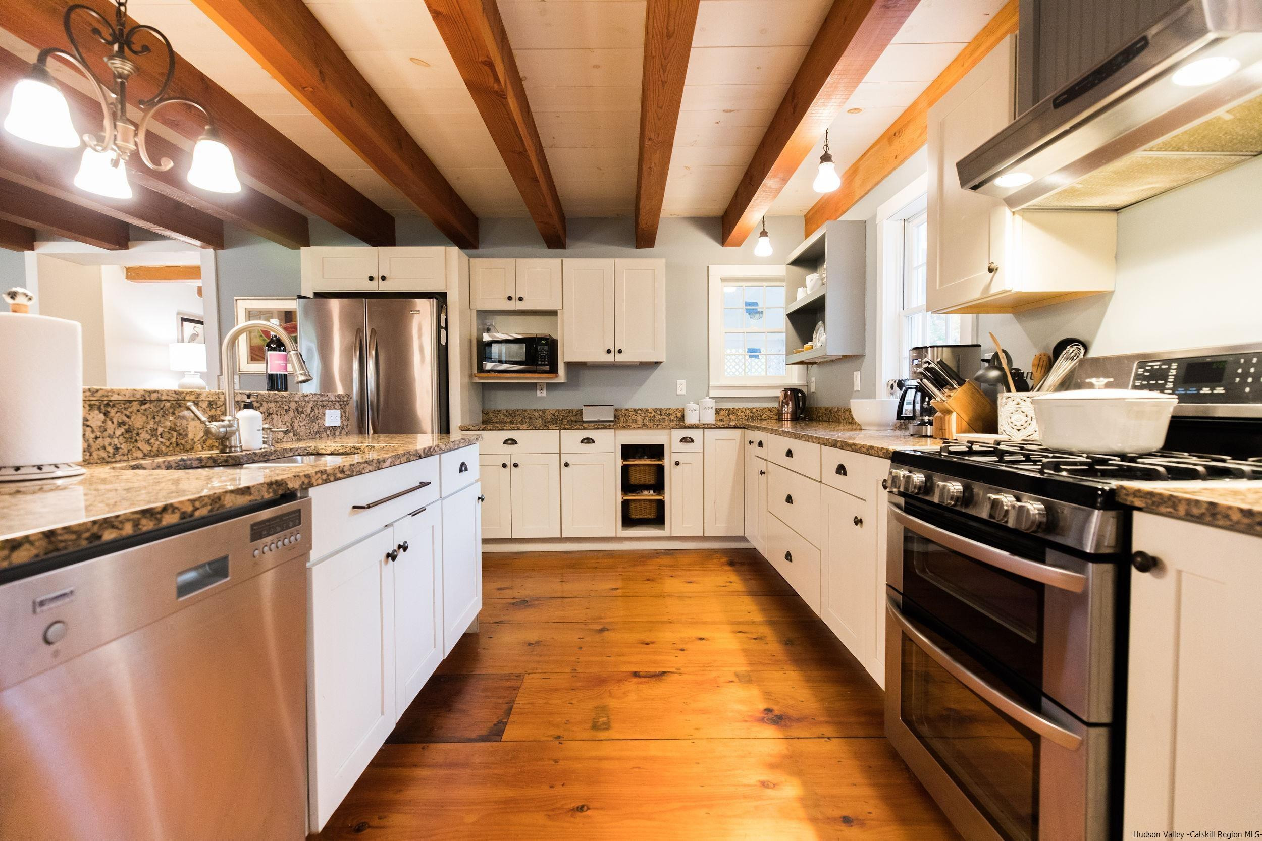 30 Old Farm Road Stone Ridge, NY 12484 - Photo 8 of 30 a large kitchen with stainless steel appliances granite countertop a stove a sink dishwasher and white cabinets with wooden floor