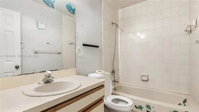 a bathroom with a granite countertop sink a toilet and shower