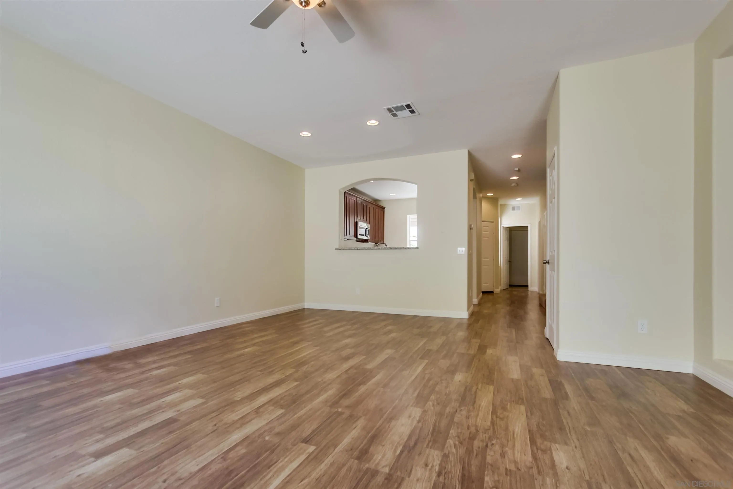 1201 Trapani Cove, Unit 4 Chula Vista, CA 91915 - Photo 11 of 37 an empty room with wooden floor and windows