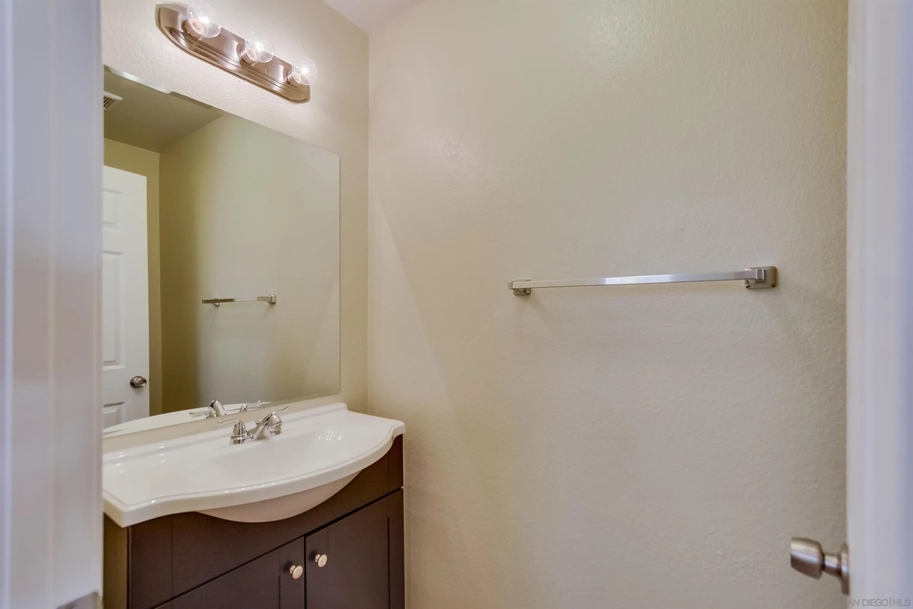 1201 Trapani Cove, Unit 4 Chula Vista, CA 91915 - Photo 12 of 37 a bathroom with a sink and a mirror