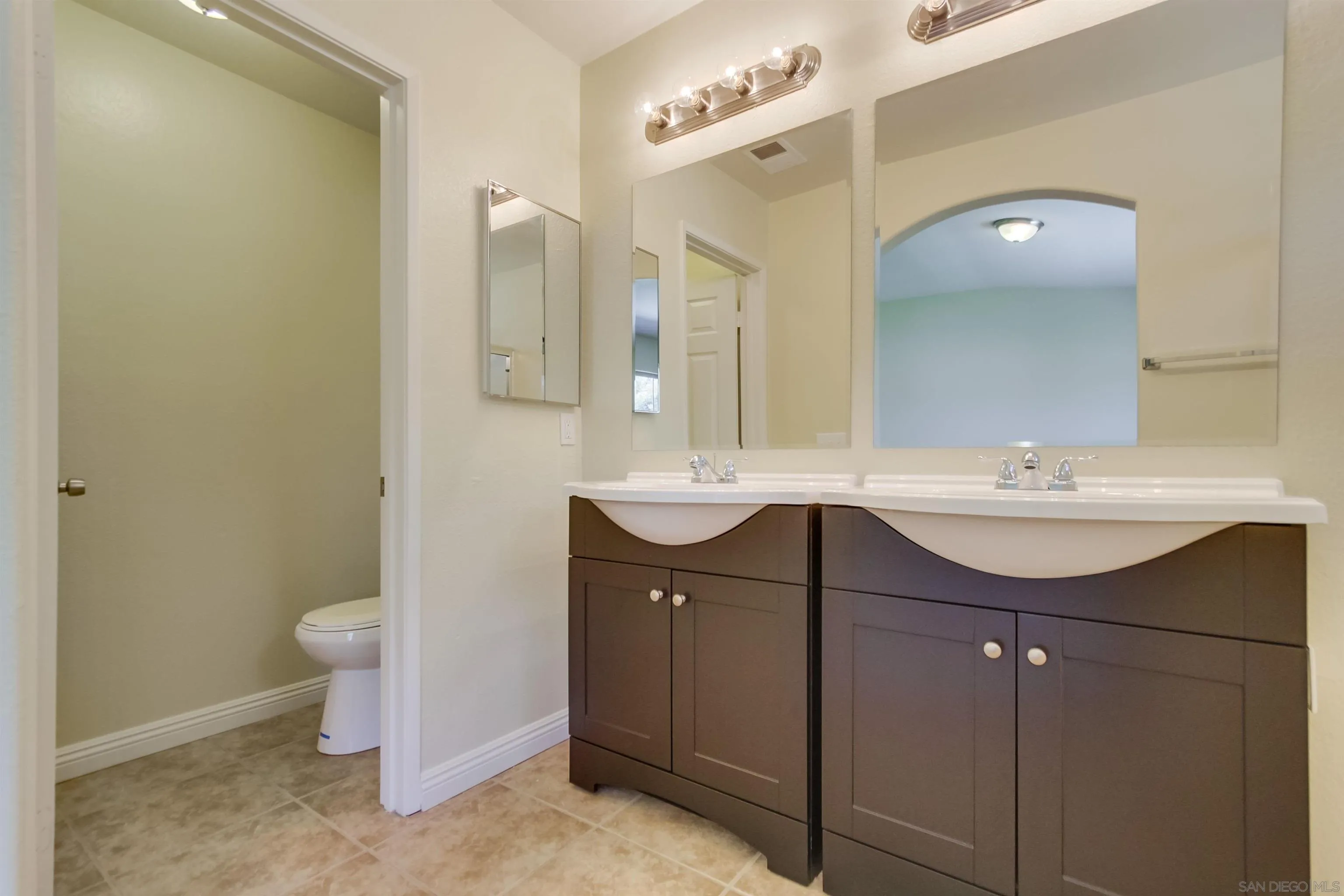1201 Trapani Cove, Unit 4 Chula Vista, CA 91915 - Photo 15 of 37 a bathroom with a sink and a mirror