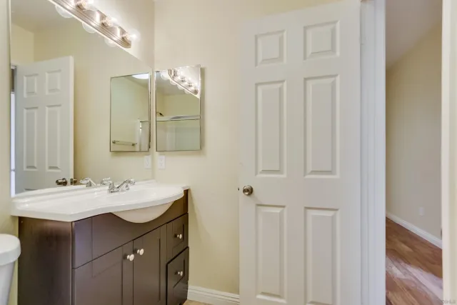 a bathroom with a double vanity sink and a mirror