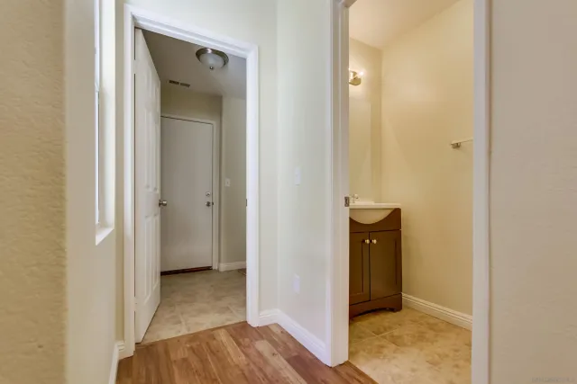 a view of a hallway with wooden floor