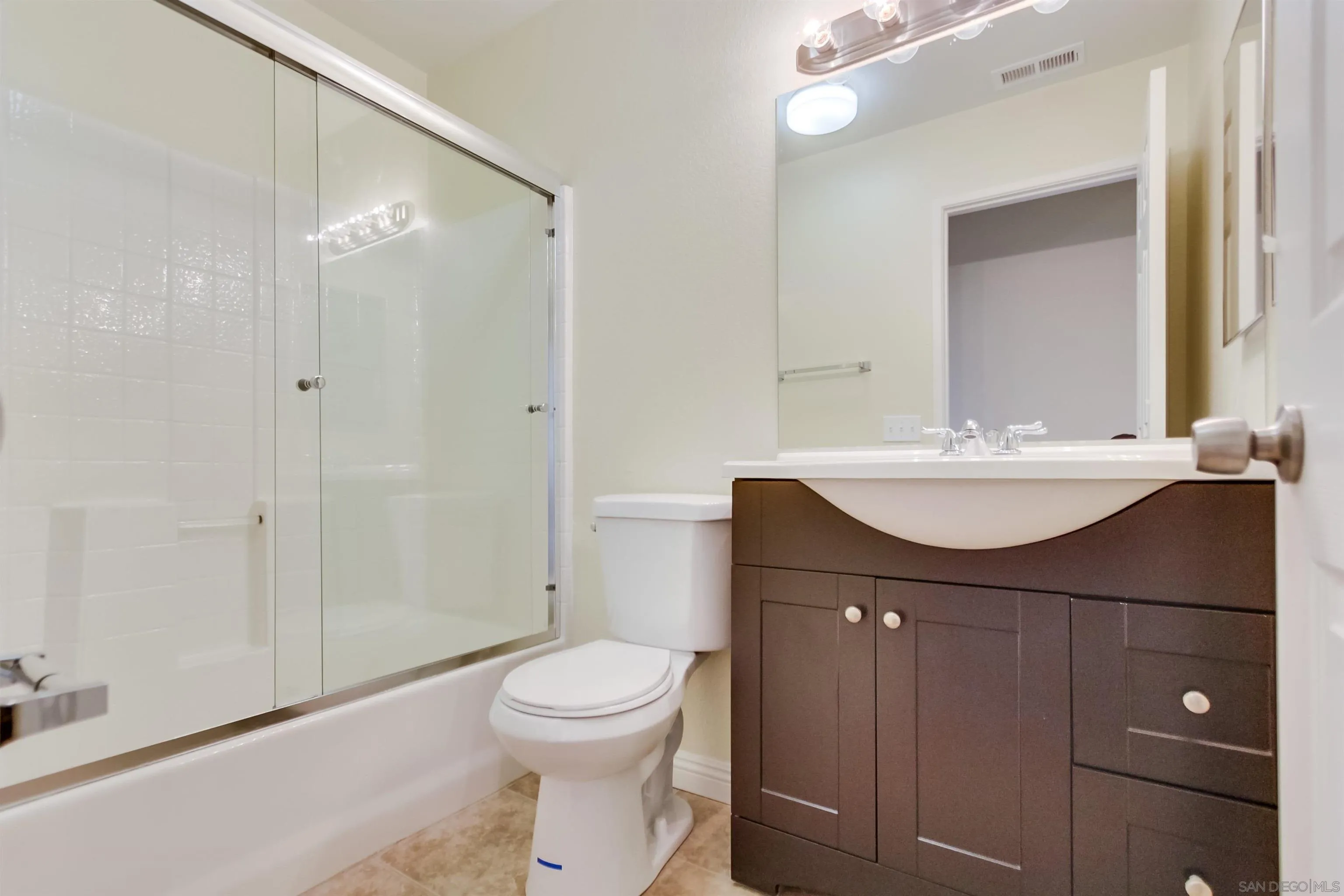 1201 Trapani Cove, Unit 4 Chula Vista, CA 91915 - Photo 27 of 37 a bathroom with a sink vanity toilet and shower