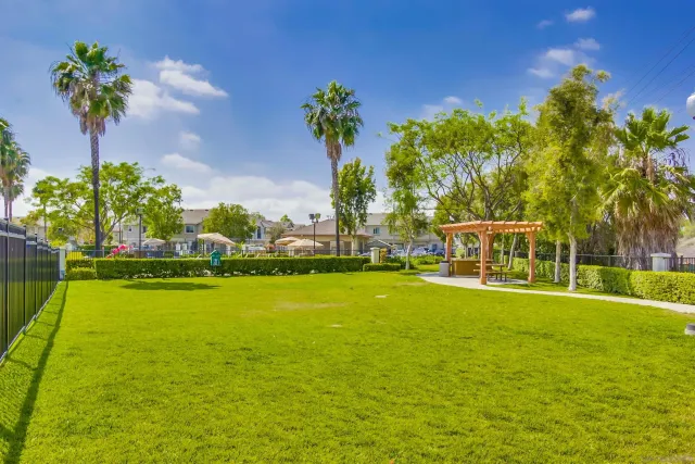 a view of an ocean with house in the background