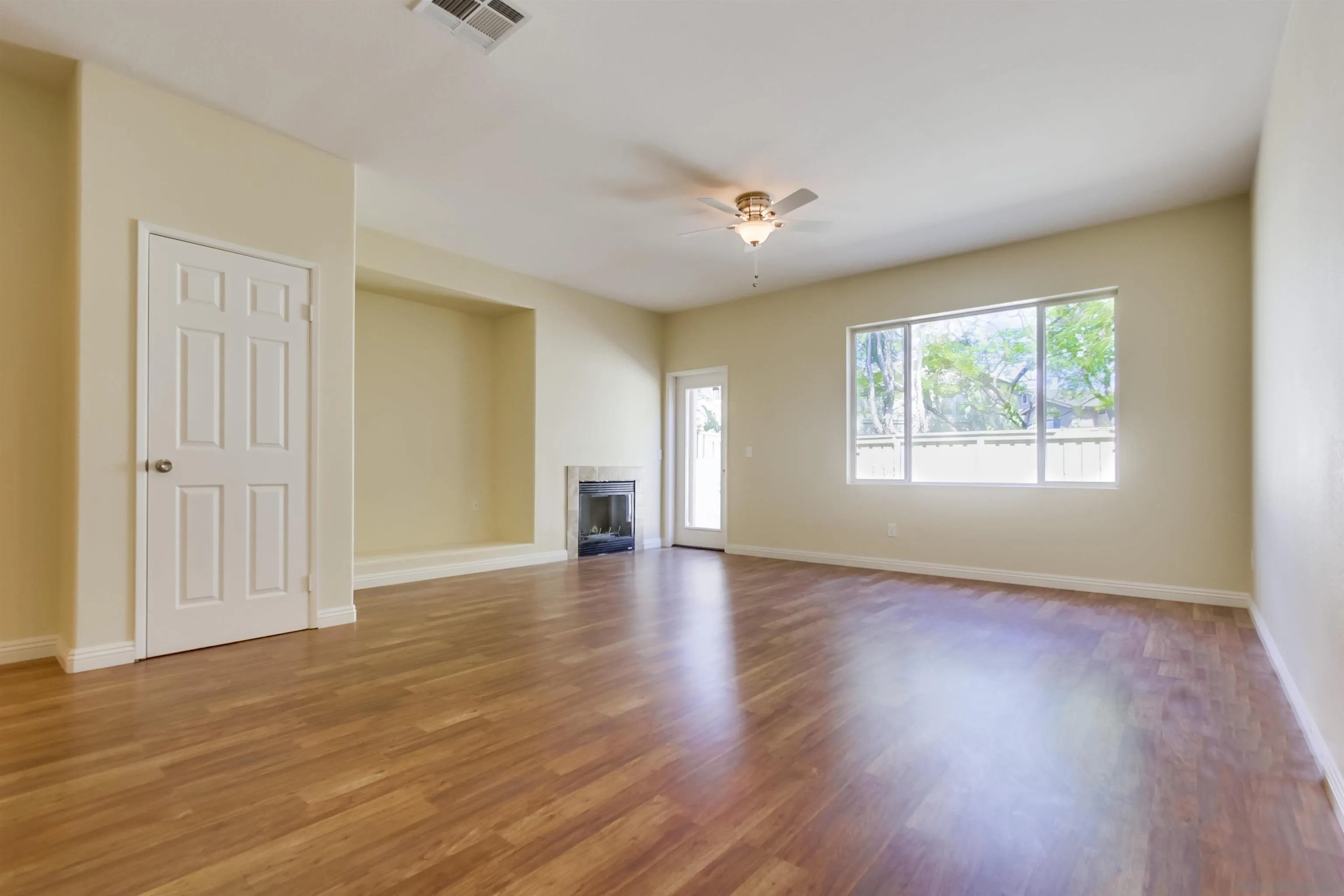 1201 Trapani Cove, Unit 4 Chula Vista, CA 91915 - Photo 8 of 37 an empty room with wooden floor and windows